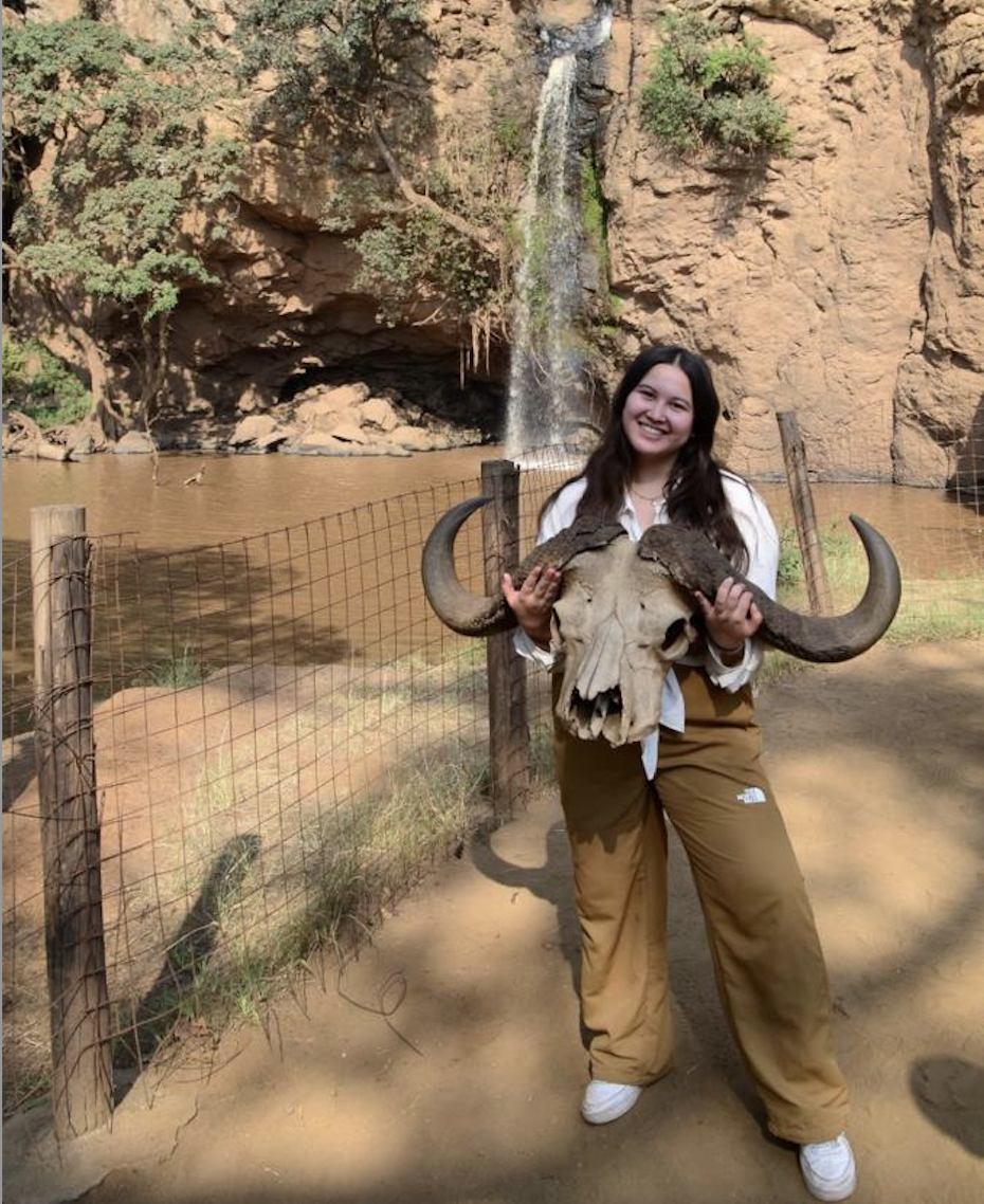 Sabriya at Lake Nakuru National Park holding a buffalo skull.